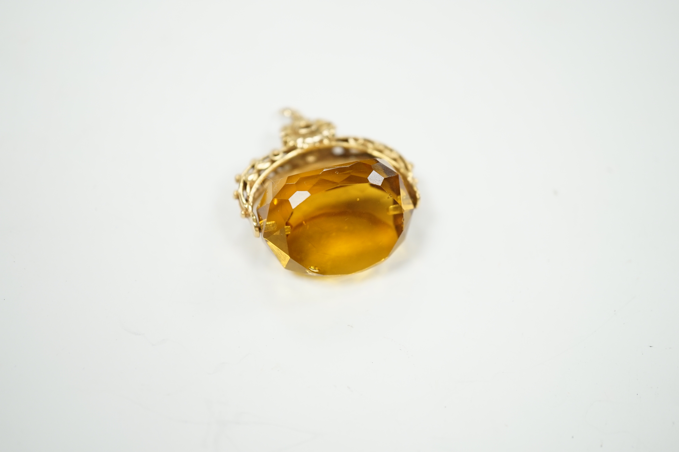 A 9ct and citrine coloured paste set swivelling fob, 30mm, gross weight 14.7 grams.